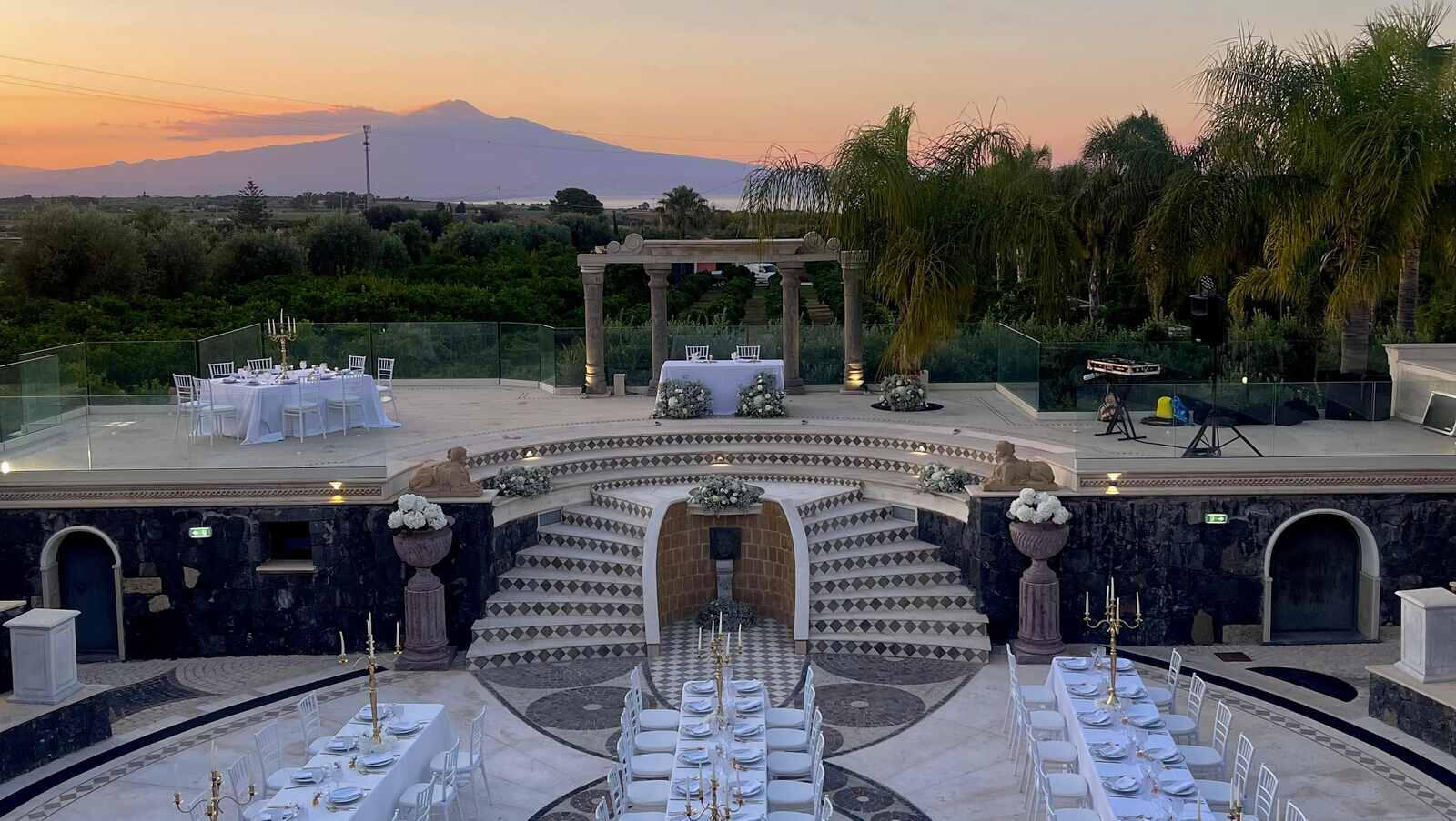 Thalos Thalos casa comunale near Augusta, wedding tables in the amphitheatre at dusk with Etna behind